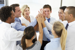 Close Up Of Business People Joining Hands In Team Building Exercise